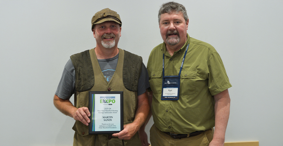 Marty Sands holding award, next to Paul Wait